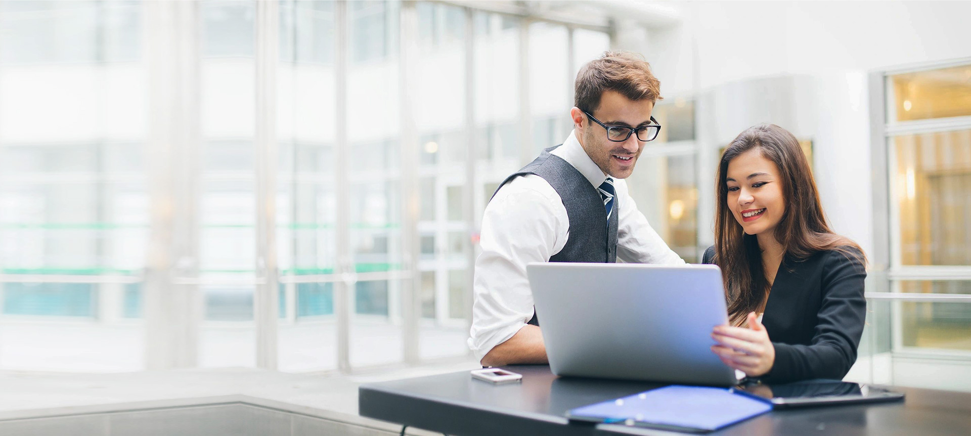 A man sitting at a table with a laptop.